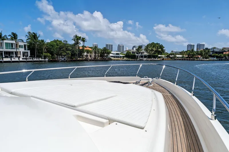 Blue Abalone Yacht Photos Pics Luxurious 2015 Ferretti Yachts 690 on serene waterway with cityscape backdrop.