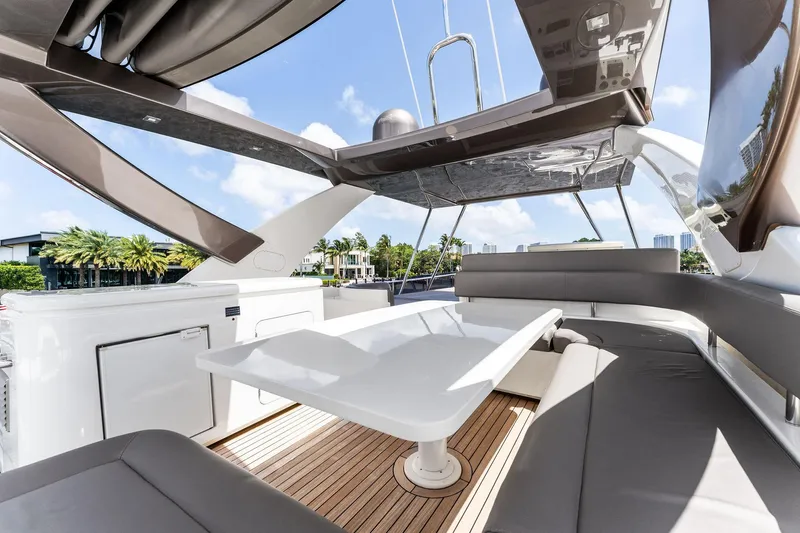 Blue Abalone Yacht Photos Pics Luxurious 2015 Ferretti Yachts 690 flybridge with elegant seating and table, under a sunny sky.