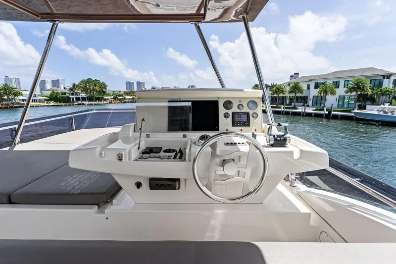 Blue Abalone Yacht Photos Pics Flybridge helm of 2015 Ferretti Yachts 690 with modern controls and waterfront view.