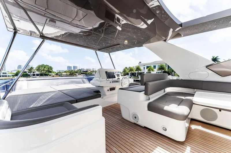 Blue Abalone Yacht Photos Pics Luxurious 2015 Ferretti Yachts 690 flybridge with modern seating and helm, docked in a marina.