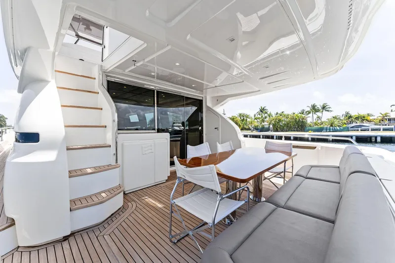 Blue Abalone Yacht Photos Pics Luxurious 2015 Ferretti Yachts 690 deck with seating, table, and staircase.