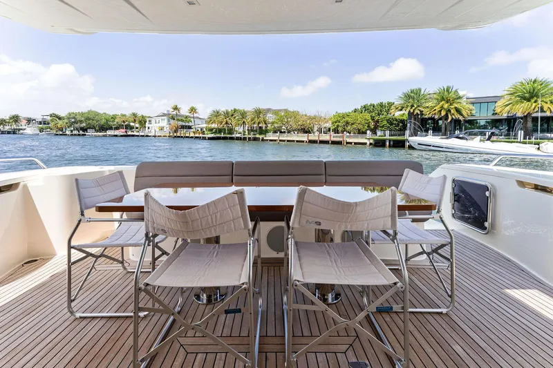 Blue Abalone Yacht Photos Pics Outdoor dining area on 2015 Ferretti Yachts 690, overlooking serene waterfront views.