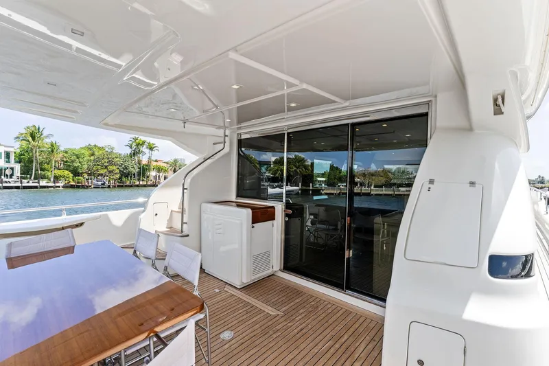 Blue Abalone Yacht Photos Pics Luxurious 2015 Ferretti Yachts 690 deck with elegant seating and scenic waterfront view.