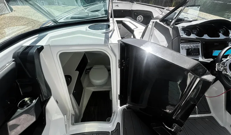  Yacht Photos Pics 2022 Monterey 298SS boat interior with open cabin door and visible toilet.