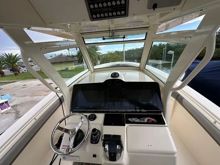 Yacht Photos Pics 2017 Scout 350 LXF boat cockpit with steering wheel and control panel.