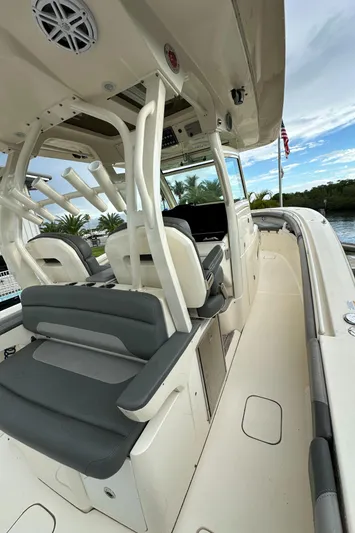  Yacht Photos Pics 2017 Scout 350 LXF boat interior with seating and helm, docked by water.