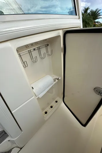  Yacht Photos Pics 2017 Scout 350 LXF boat storage compartment with hooks and paper towel holder.
