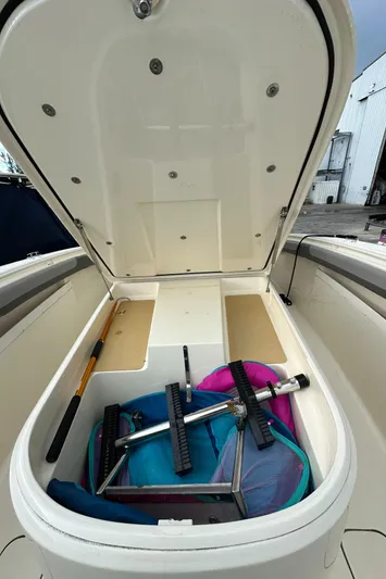  Yacht Photos Pics Open storage compartment of 2017 Scout 350 LXF boat with equipment inside.