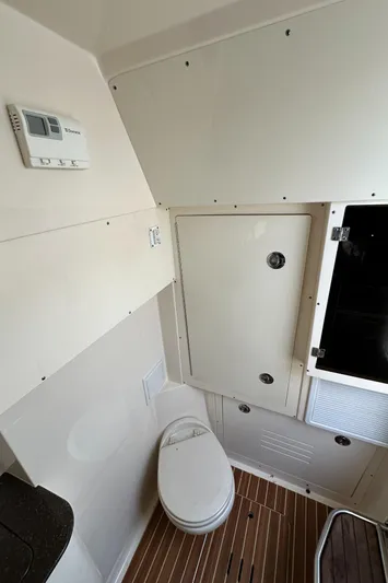  Yacht Photos Pics 2017 Scout 350 LXF boat interior bathroom with toilet and wooden flooring.