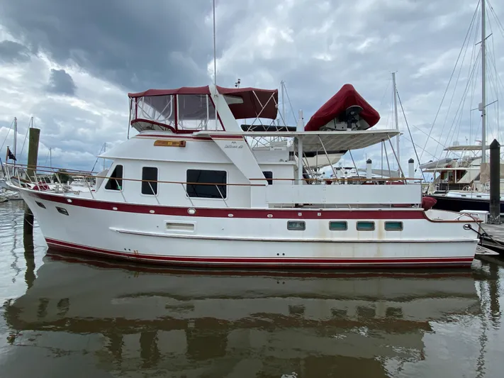 The Smithsunian Yacht Photos Pics 1989 DeFever 49 CPMY yacht docked at marina under cloudy sky.