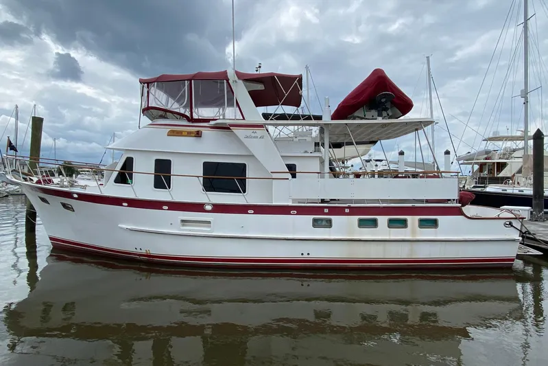The Smithsunian Yacht Photos Pics 1989 DeFever 49 CPMY yacht docked at marina under cloudy sky.