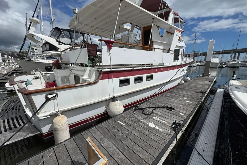 The Smithsunian Yacht Photos Pics 1989 DeFever 49 CPMY yacht docked at marina under cloudy sky.