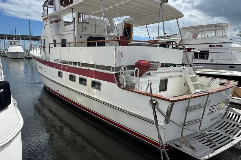 The Smithsunian Yacht Photos Pics 1989 DeFever 49 CPMY yacht docked at marina, featuring spacious deck and classic design.