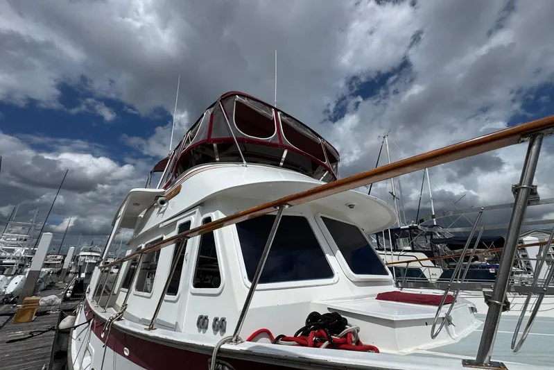 The Smithsunian Yacht Photos Pics 1989 DeFever 49 CPMY yacht docked under cloudy skies.