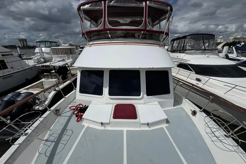The Smithsunian Yacht Photos Pics 1989 DeFever 49 CPMY yacht docked at marina under cloudy sky.