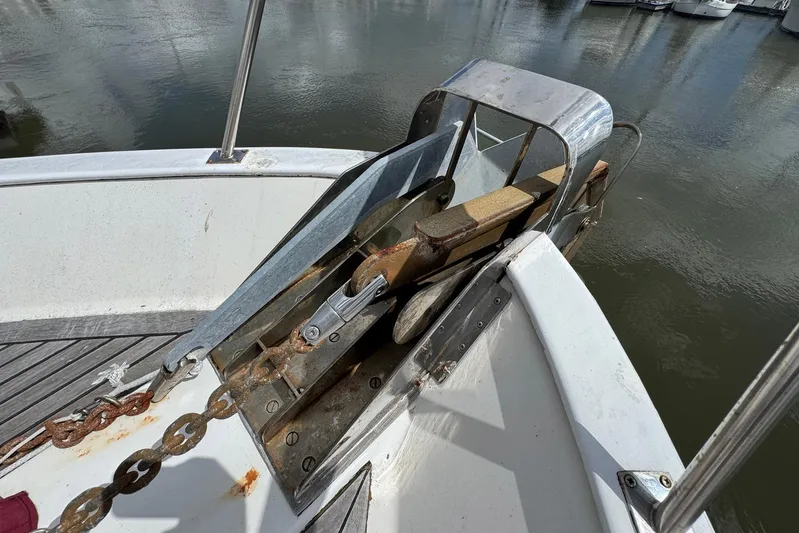 The Smithsunian Yacht Photos Pics Anchor and chain on 1989 DeFever 49 CPMY yacht deck by the water.