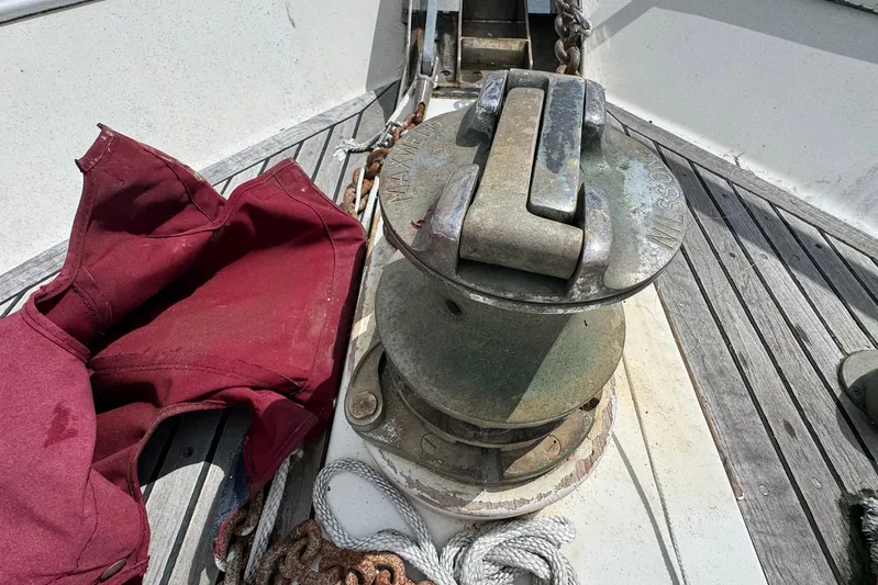 The Smithsunian Yacht Photos Pics Anchor windlass on 1989 DeFever 49 CPMY boat deck with maroon cover.