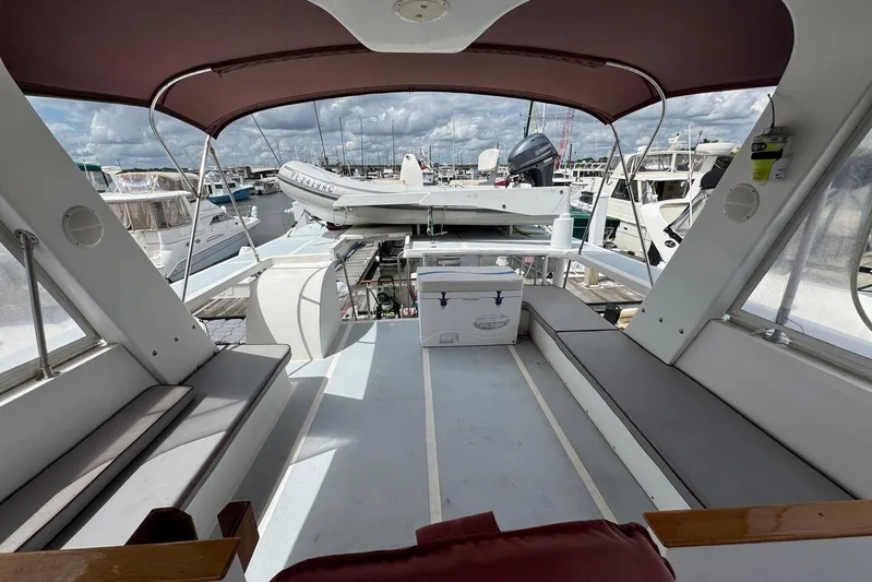 The Smithsunian Yacht Photos Pics 1989 DeFever 49 CPMY yacht deck with seating, cooler, and marina view.