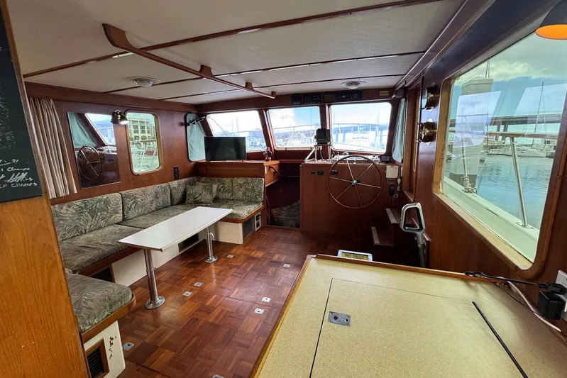 The Smithsunian Yacht Photos Pics Interior of 1989 DeFever 49 CPMY yacht with wood paneling and seating area.