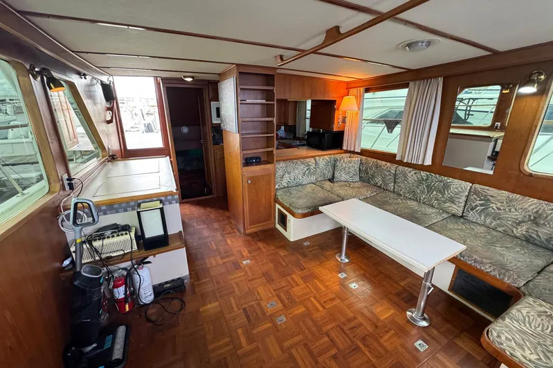 The Smithsunian Yacht Photos Pics Interior of 1989 DeFever 49 CPMY yacht with wood paneling and cushioned seating.