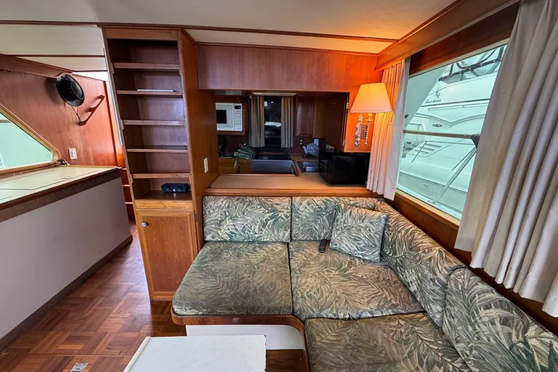 The Smithsunian Yacht Photos Pics Interior of 1989 DeFever 49 CPMY yacht with cozy seating and wooden accents.