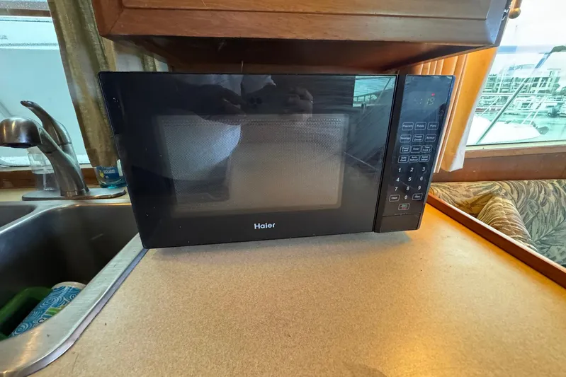 The Smithsunian Yacht Photos Pics Haier microwave on countertop inside 1989 DeFever 49 CPMY yacht kitchen.