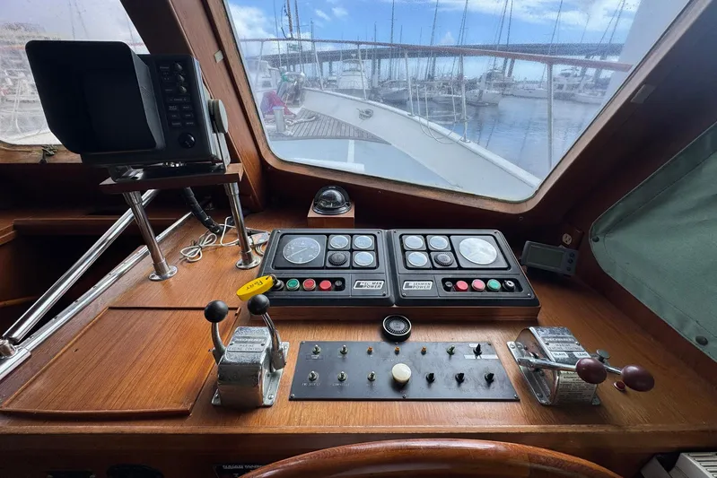 The Smithsunian Yacht Photos Pics 1989 DeFever 49 CPMY helm with navigation controls and marina view.