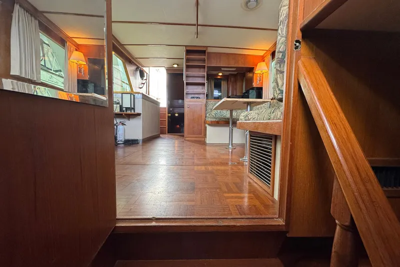 The Smithsunian Yacht Photos Pics Interior of 1989 DeFever 49 CPMY yacht with wooden flooring and cozy seating area.