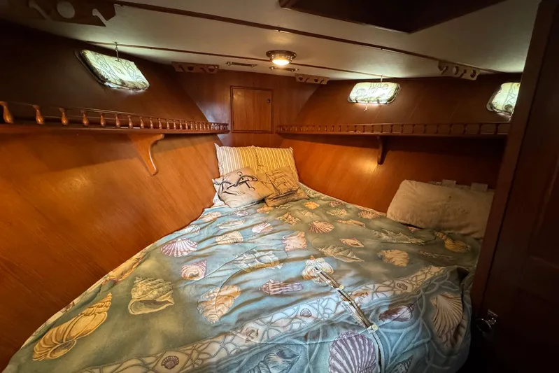 The Smithsunian Yacht Photos Pics Cozy cabin bedroom in 1989 DeFever 49 CPMY yacht with seashell-themed bedding.