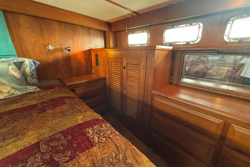 The Smithsunian Yacht Photos Pics 1989 DeFever 49 CPMY cabin interior with wood paneling and cozy bed.