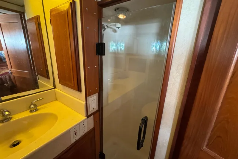 The Smithsunian Yacht Photos Pics Bathroom interior of 1989 DeFever 49 CPMY yacht with shower and sink.