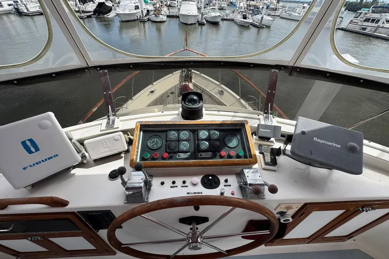 The Smithsunian Yacht Photos Pics 1989 DeFever 49 CPMY yacht helm with navigation equipment and marina view.