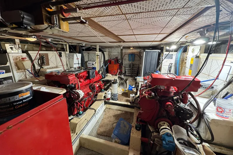 The Smithsunian Yacht Photos Pics Engine room of 1989 DeFever 49 CPMY yacht with red machinery and equipment.
