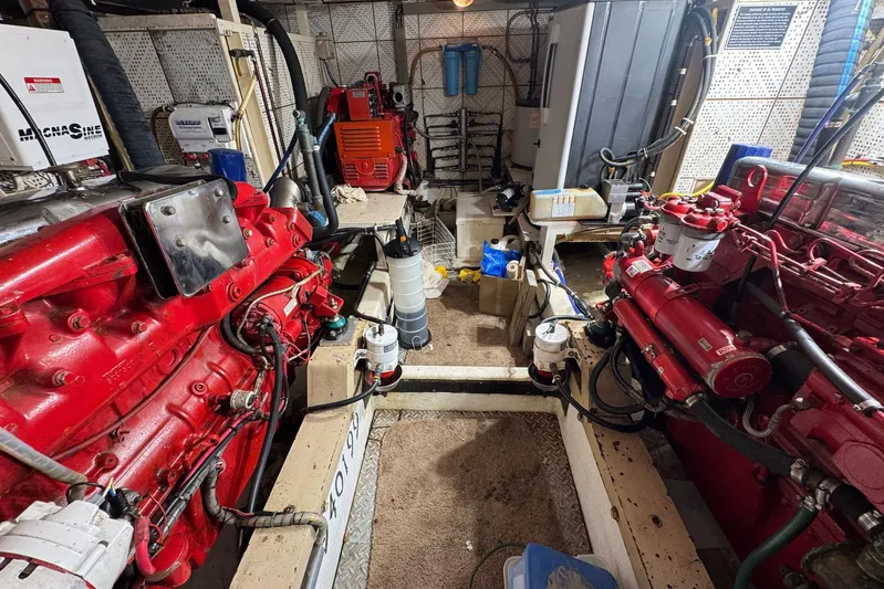 The Smithsunian Yacht Photos Pics Engine room of 1989 DeFever 49 CPMY yacht with red machinery and equipment.