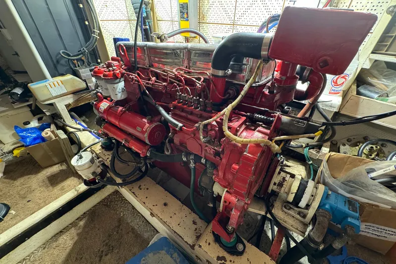 The Smithsunian Yacht Photos Pics Engine room of 1989 DeFever 49 CPMY with red marine engine components.