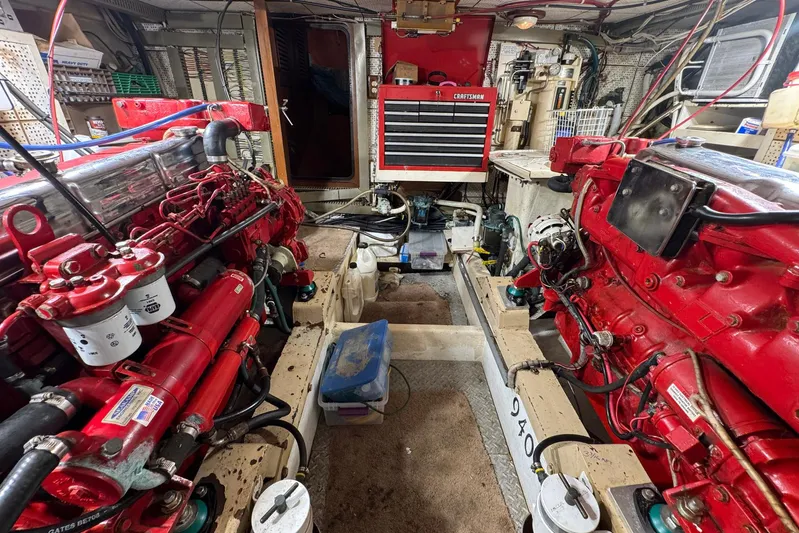 The Smithsunian Yacht Photos Pics Engine room of 1989 DeFever 49 CPMY yacht with red machinery and tools.