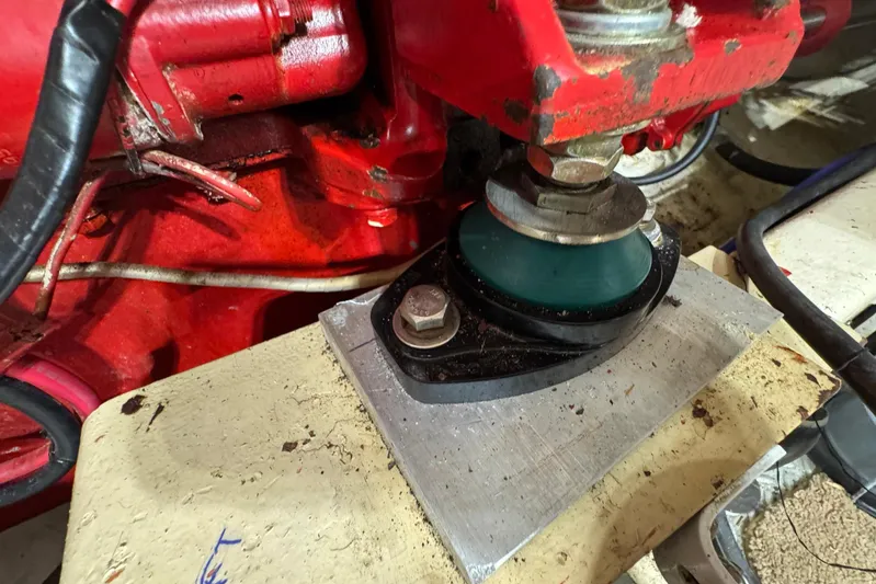 The Smithsunian Yacht Photos Pics Engine mount detail on 1989 DeFever 49 CPMY boat, showing red machinery and bolts.