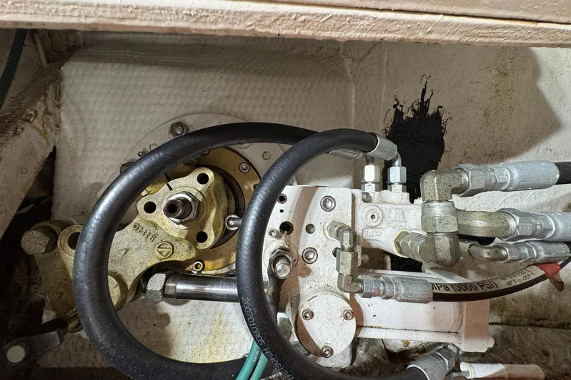 The Smithsunian Yacht Photos Pics Engine compartment of a 1989 DeFever 49 CPMY with hydraulic components and hoses.