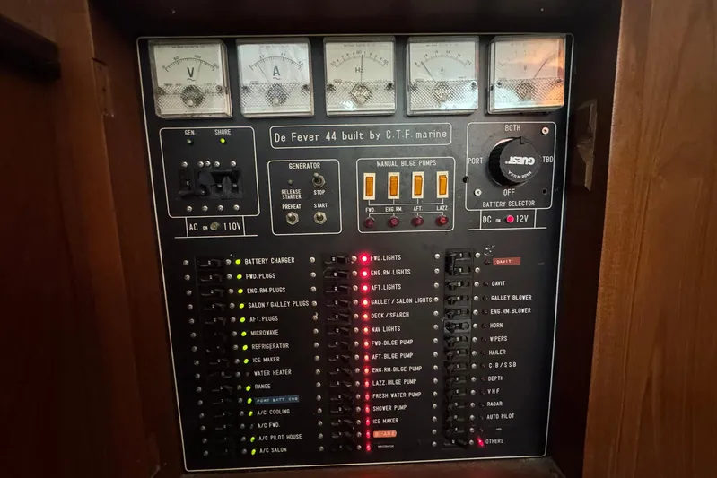 The Smithsunian Yacht Photos Pics Electrical control panel of a 1989 DeFever 49 CPMY yacht with various switches and gauges.