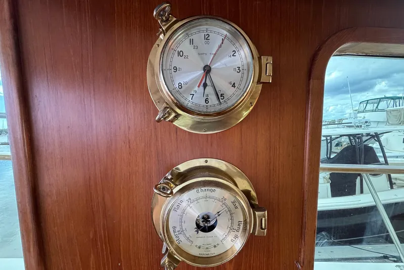 The Smithsunian Yacht Photos Pics Brass clock and barometer on 1989 DeFever 49 CPMY yacht interior.