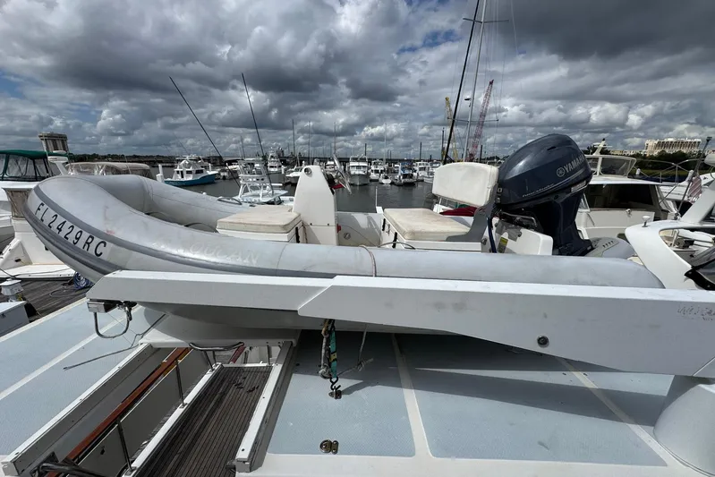 The Smithsunian Yacht Photos Pics 1989 DeFever 49 CPMY yacht with inflatable boat and Yamaha motor at marina.