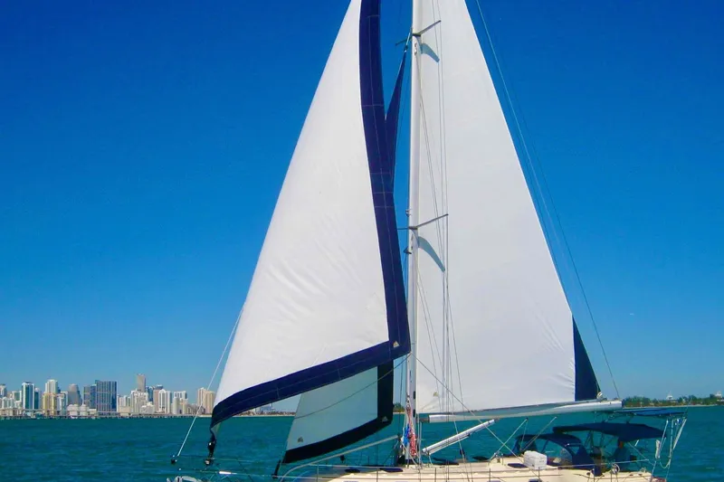 Second Wind Yacht Photos Pics Sailing yacht Island Packet 440, 2006 model, with city skyline in the background.
