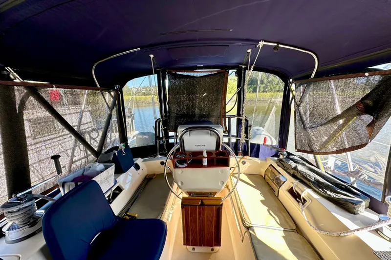Second Wind Yacht Photos Pics Interior view of 2006 Island Packet 440 sailboat cockpit with seating and steering wheel.