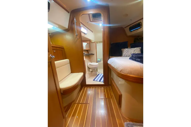 Second Wind Yacht Photos Pics Interior of 2006 Island Packet 440 yacht with cozy cabin and wooden flooring.