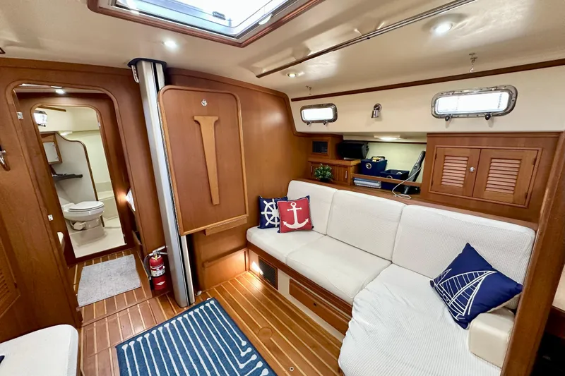 Second Wind Yacht Photos Pics Interior of 2006 Island Packet 440 yacht with cozy seating and nautical decor.