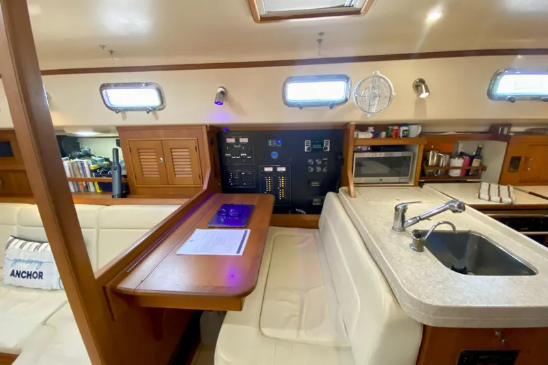 Second Wind Yacht Photos Pics Interior of 2006 Island Packet 440 yacht with kitchen and seating area.