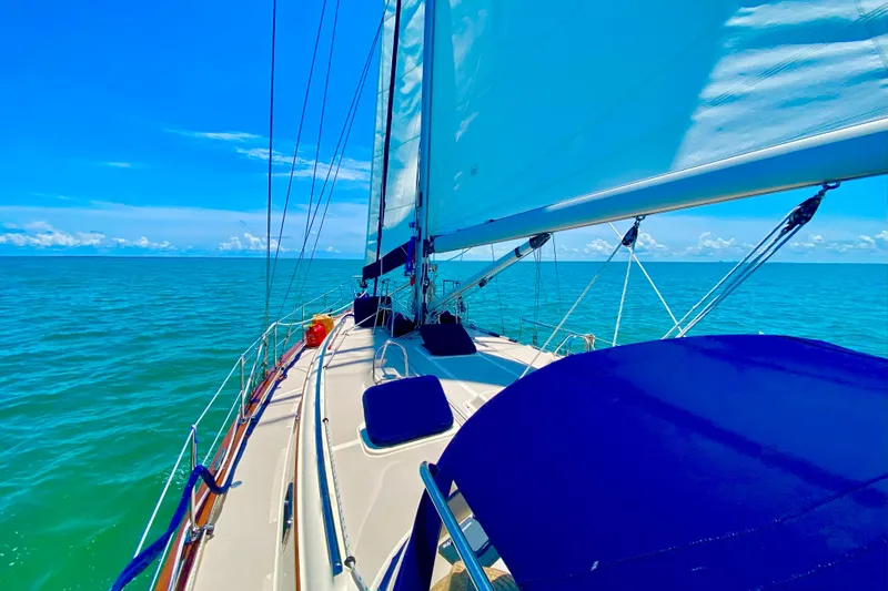 Second Wind Yacht Photos Pics Sailing on a 2006 Island Packet 440 yacht under clear blue skies and calm sea.