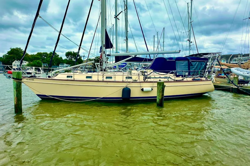 Second Wind Yacht Photos Pics 2006 Island Packet 440 sailboat docked in a marina under cloudy skies.