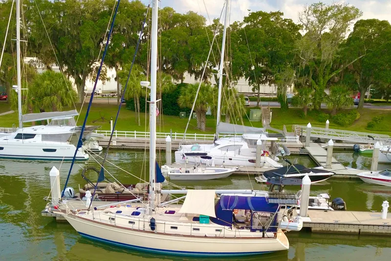 Second Wind Yacht Photos Pics Sailboat docked at marina, Island Packet 440, 2006 model, surrounded by lush greenery.