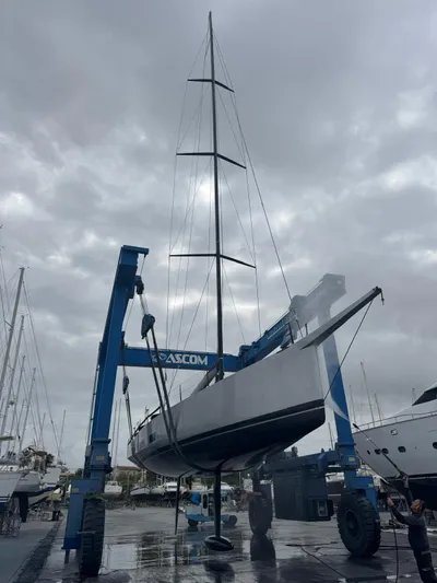 Sn Yacht Photos Pics Vismara V62 Mills yacht from 2015 being lifted by a crane in a marina.